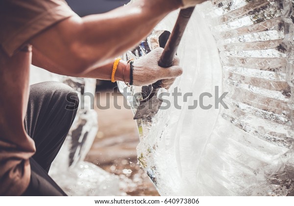 man is carving\
the ice sculpture for\
wedding