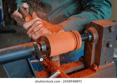 Man Carving wood on a woodworking lathe - Powered by Shutterstock