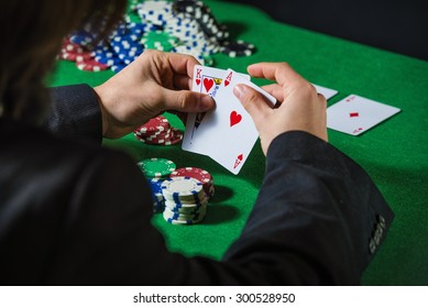 Man in casino with couple of ace and king
