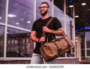 Man Casual Fashion. Man walking street with duffel canvas bag