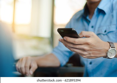 man in casual form using mobile phone at the cafe - Powered by Shutterstock