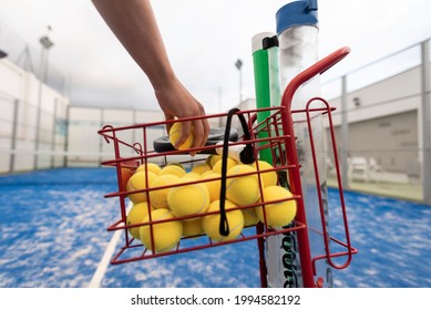 man catches balls to train with paddle tennis on a cloudy day - Powered by Shutterstock