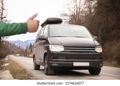 Man catching car on road, closeup. Hitchhiking trip