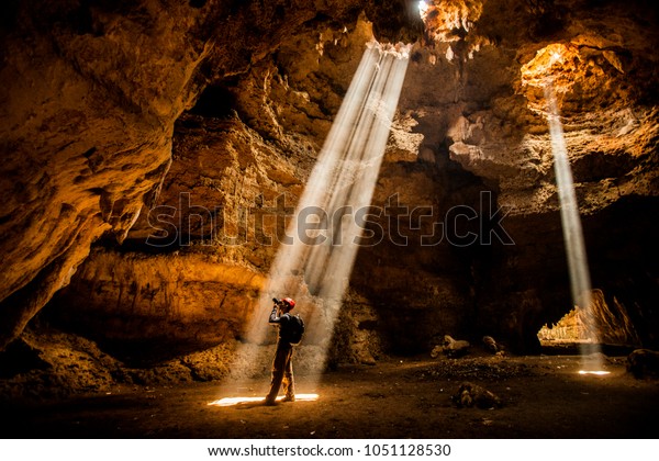 Man in the cave\
exploration with Ray of\
light