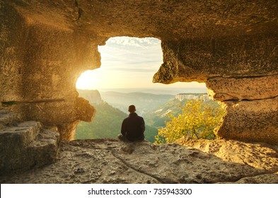 Man in cave mountain. Conceptual scene. 