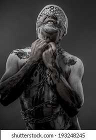 man with chains and blindfolded concept of prison, without freedom