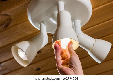 A Man Changes An Electric Light Bulb, Energy Efficiency