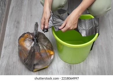 A Man Changes A Garbage Bag In A Bucket. Woman Tearing Off A Trash Bag. High Quality Photo