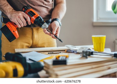 Man Changing Drill Bit On A Cordless Drill