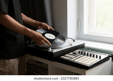 man changing record on vinyl player