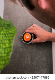 Man Changing Temperature using Digital Home Thermostat