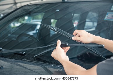 Man is changing windscreen wipers on a car - Powered by Shutterstock