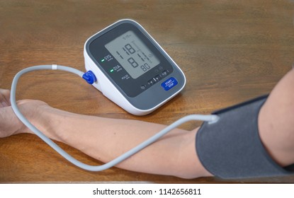 man check blood pressure monitor and heart rate with digital pressure gauge. and Don't take the measurement over clothes.