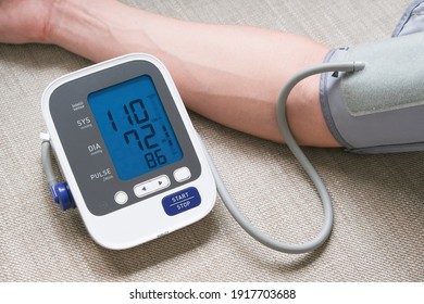 Man Check Blood Pressure Monitor And Heart Rate Monitor With Digital Pressure Gauge. Health Care And Medical Concept