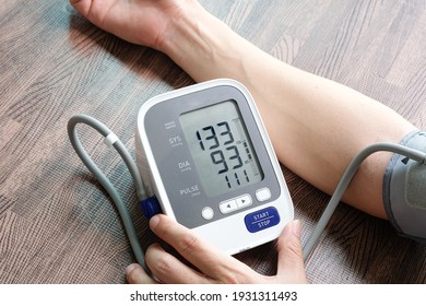 Man Check Blood Pressure Monitor And Heart Rate Monitor With Digital Pressure Gauge. Health Care And Medical Concept