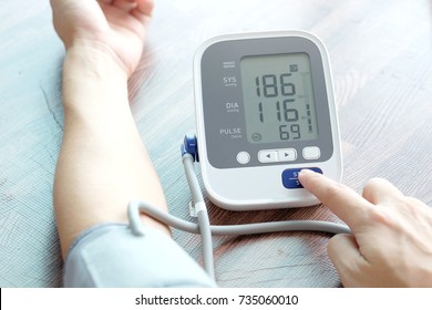 Man Check Blood Pressure Monitor And Heart Rate Monitor With Digital Pressure Gauge. Health Care And  Medical Concept