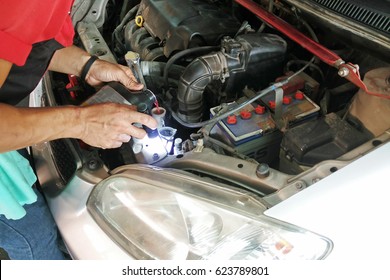 A Man Check Car Coolant Level And Refill Car Coolant In Garage.