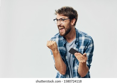 Man in checkered shirt smartphone emotion technology fixture