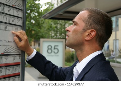 Man checking a bus timetable