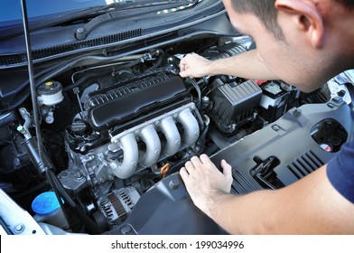 A man checking car engine