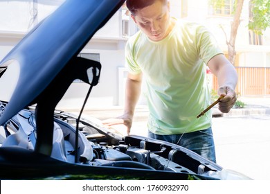 A Man Checking Car Engine At Home