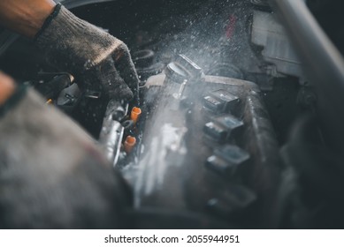 Man With Checking Car Engine, Mechanic Fixing A Car Engine, Mechanic Fixing Spark Plug To Open Car Engine With Ratchet, Visible Camshafts, Pulley, Belt, Timing Chain