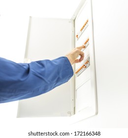 Man Checking The Electrical Fuse Box At His House To See If Any Of The Circuit Breakers Have Tripped