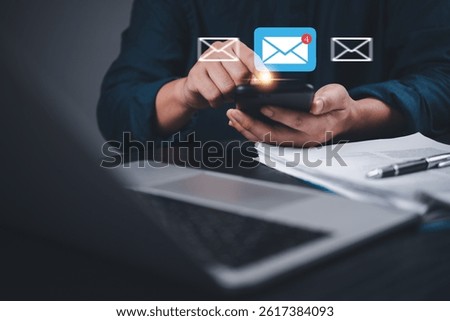 Man checking email alert pops up on smartphone with notification icon. Digital communication, mobile messaging and smart connectivity.Online contact, remote work