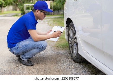 A man checking and fixing a broken car on the side of the road. Problems with broken cars on the highway Man looking under the hood of a roadside assistance concept car. - Shutterstock ID 2206109677