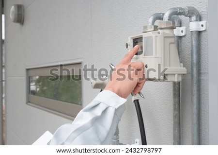 A man checking the gas meter