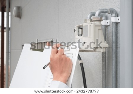 A man checking the gas meter
