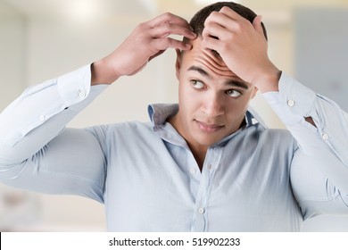 Man Checking Hairline, In A Bathroom