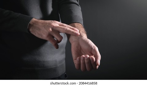 Man Checking Heart Rate Pulse On Wrist.