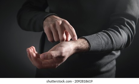 Man Checking Heart Rate Pulse On Wrist.