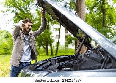 Man checking his broke down car.