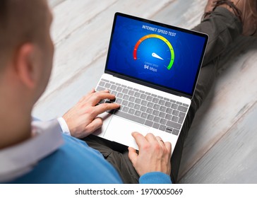 Man checking internet connection speed on laptop