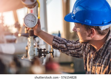 Man checking manometer in natural gas factory - Shutterstock ID 576154828