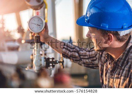 Man checking manometer in natural gas factory
