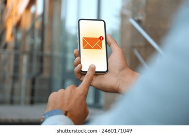 Man checking new message on mobile phone outdoors, closeup - Powered by Shutterstock