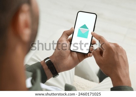 Man checking new message on mobile phone, closeup