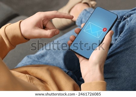 Man checking new message on mobile phone indoors, closeup