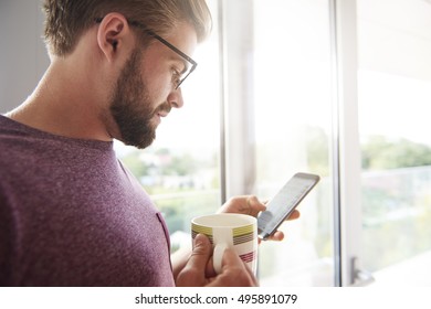 Man Checking News By Mobile Phone 