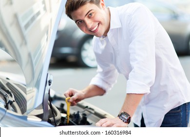 Man Checking Oil Level In Car 