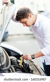 Man Checking Oil Level In Car 