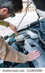 Man Checking Oil Level In Car