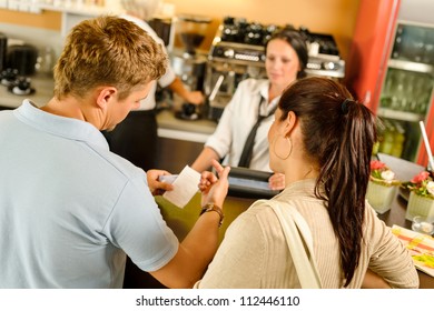 Man Checking Receipt At Cafe Restaurant Payment Waitress Couple Bar