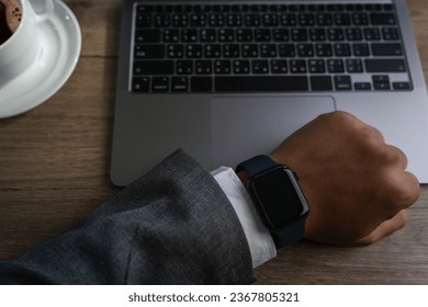 Man checking time on his smartwatch device Close-up display clock checking lifestyle communication phone mobile touch app technology