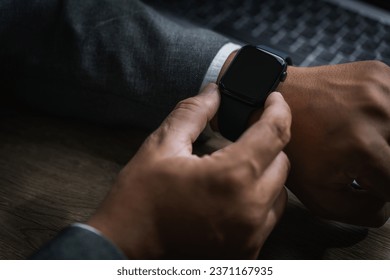 Man checking time on his smartwatch device Close-up display clock checking lifestyle communication phone mobile touch app technology