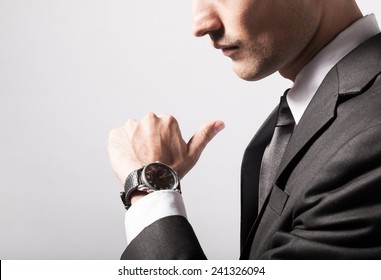 Man Checking The Time On His Wrist Watch