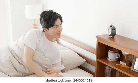 A man checking the time on his alarm clock